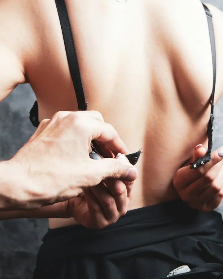His hands closing her bra