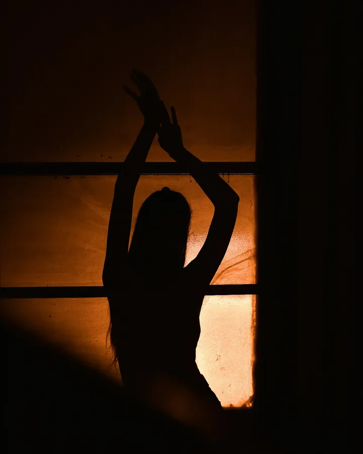 Silhouette of a woman at a window